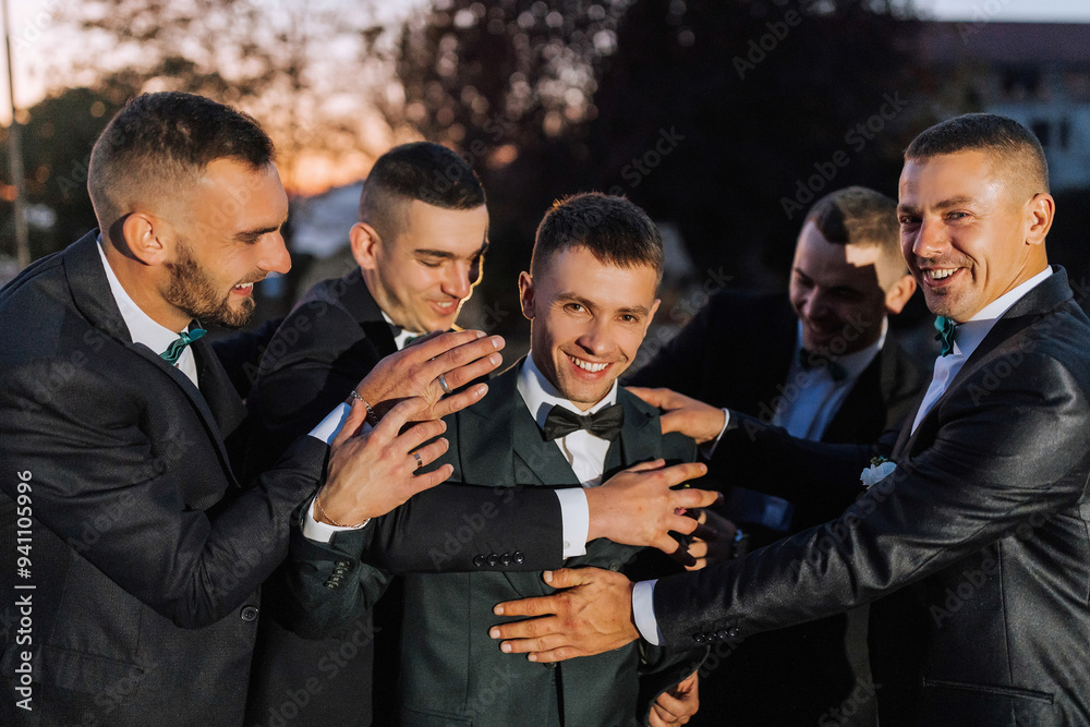 A group of men in suits are hugging each other. Scene is happy and friendly A group of men in suits are hugging each other. Scene is happy and friendly