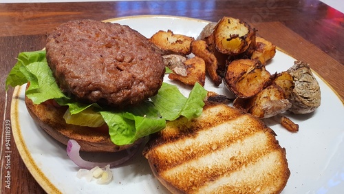 Open Burger on a Plate with Side of Crispy Potatoes – A Delicious Meal