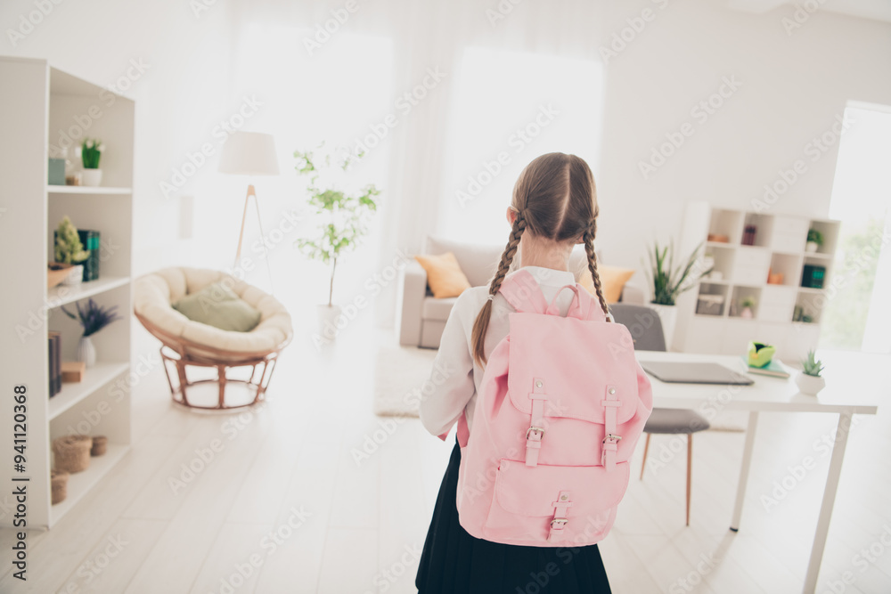 Rear portrait of lovely little schoolchild backpack wear uniform living room flat indoors Rear portrait of lovely little schoolchild backpack wear uniform living room flat indoors