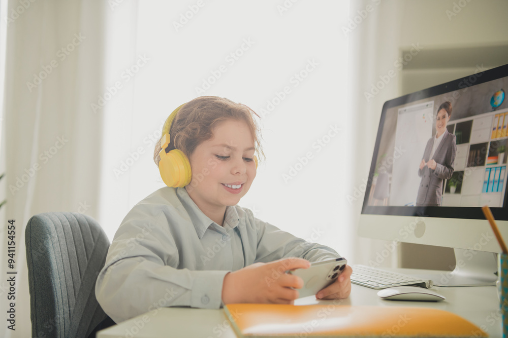 Photo of charming cheerful funny girl schoolkid sitting chair table studying from home modern technology apartment daylight indoors Photo of charming cheerful funny girl schoolkid sitting chair table studying from home modern technology apartment daylight indoors