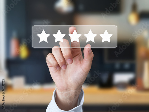 Female hand clicking on five stars on virtual screen to rate customer service photo