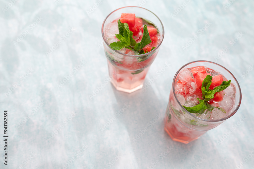 Homemade summer watermelon lemonade with ice and mint on light background, place for text Homemade summer watermelon lemonade with ice and mint on light background, place for text