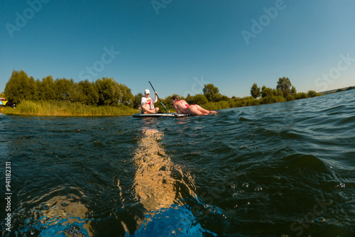 Women Enjoying Paddleboarding on a Sunny Day photo