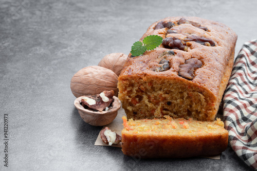 Homemade carrot and walnut loaf cake on gray table photo