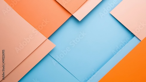 A composition of overlapping colored papers in orange and blue, creating an abstract design.