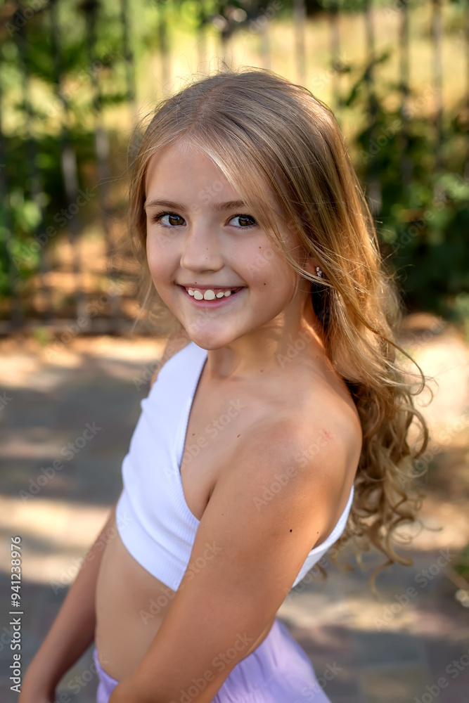 a young girl with blonde hair wearing a white top and a white shirt.