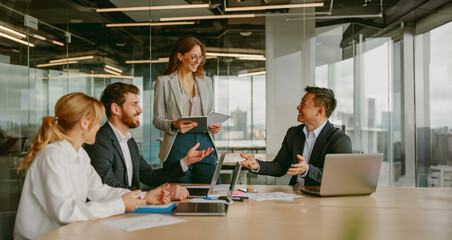 A collaborative business meeting involving professionals who are actively engaged in discussion and presentation