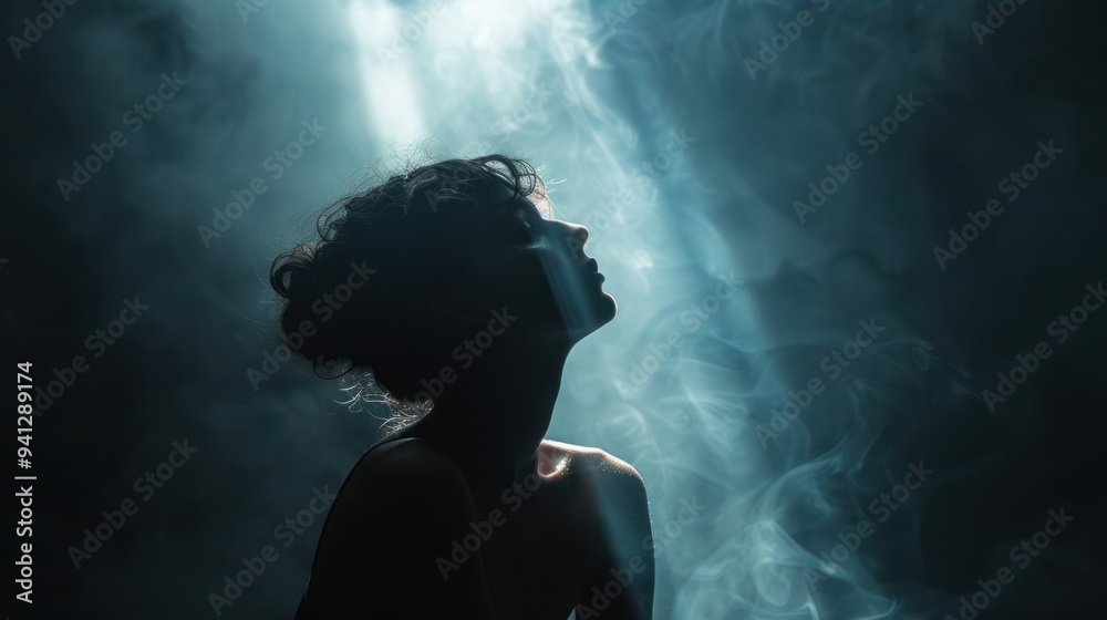 A silhouette of a person against a bright light source, creating a striking contrast between light and shadow A silhouette of a person against a bright light source, creating a striking contrast between light and shadow