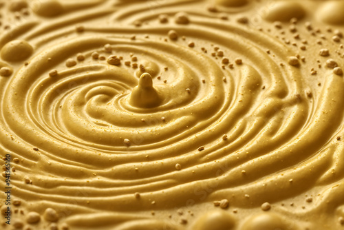 Yellow mustard sauce with seeds of charlock on top, delicious yellow creme, smooth and wavy. Food background,  texture, wallpaper or banner.  photo