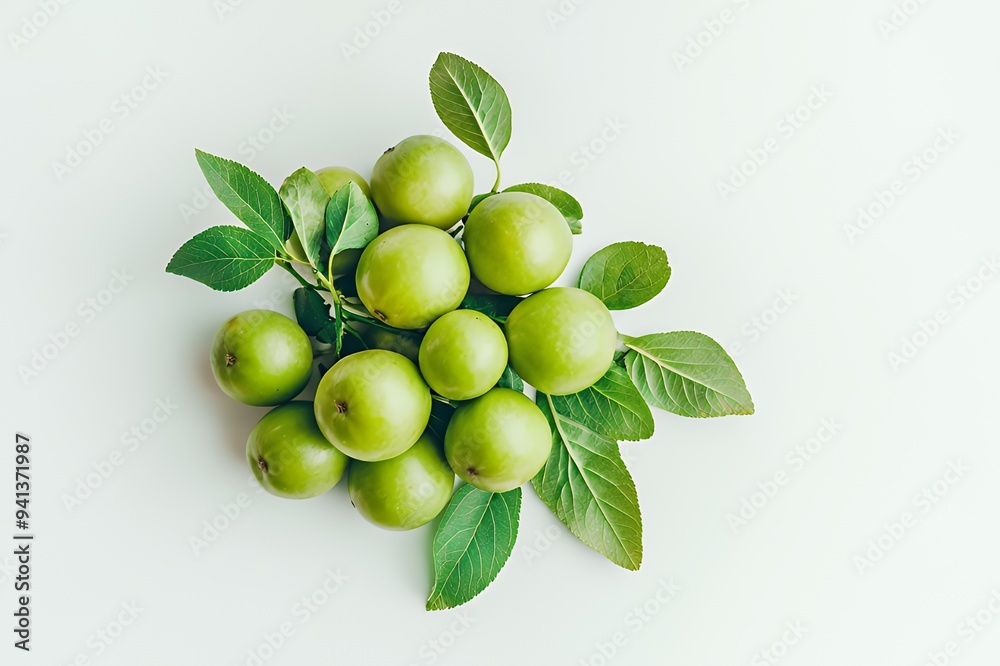 A cluster of green apples with leaves on a light background. A cluster of green apples with leaves on a light background.