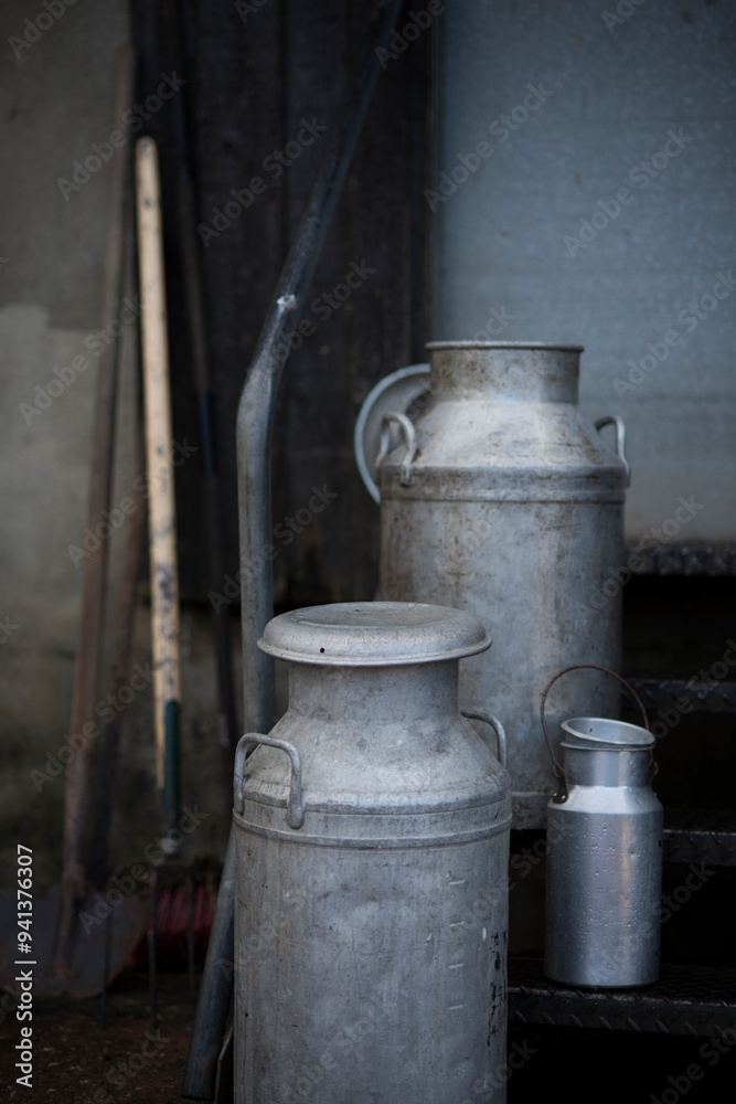 Different sizes of traditional milk churns on a Devon farm, UK. Different sizes of traditional milk churns on a Devon farm, UK.