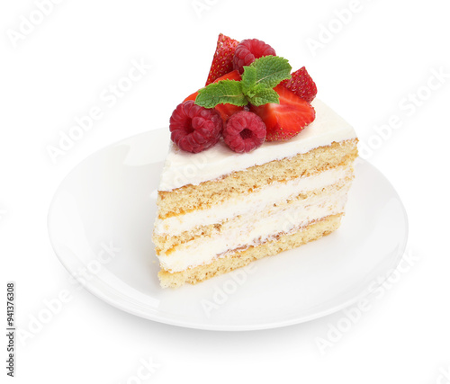 Piece of tasty sponge cake with fresh berries and mint isolated on white