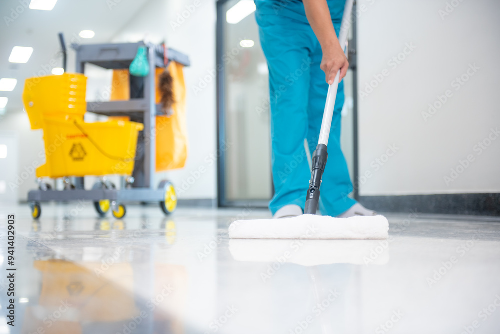 custom made wallpaper toronto digitalA mop operator in a blue uniform cleans new epoxy floor protection suits in an empty hospital warehouse.