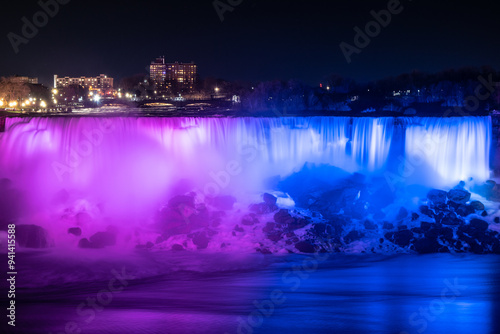 American and Bridal Veil Waterfalls. Blurred streams of Niagara Falls, illuminated in blue and purple in the evening. Canada. photo