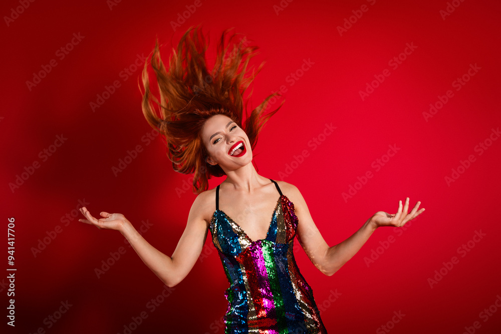 Photo of gorgeous pretty young woman throw flying hair shiny dress isolated on bright red color background Photo of gorgeous pretty young woman throw flying hair shiny dress isolated on bright red color background