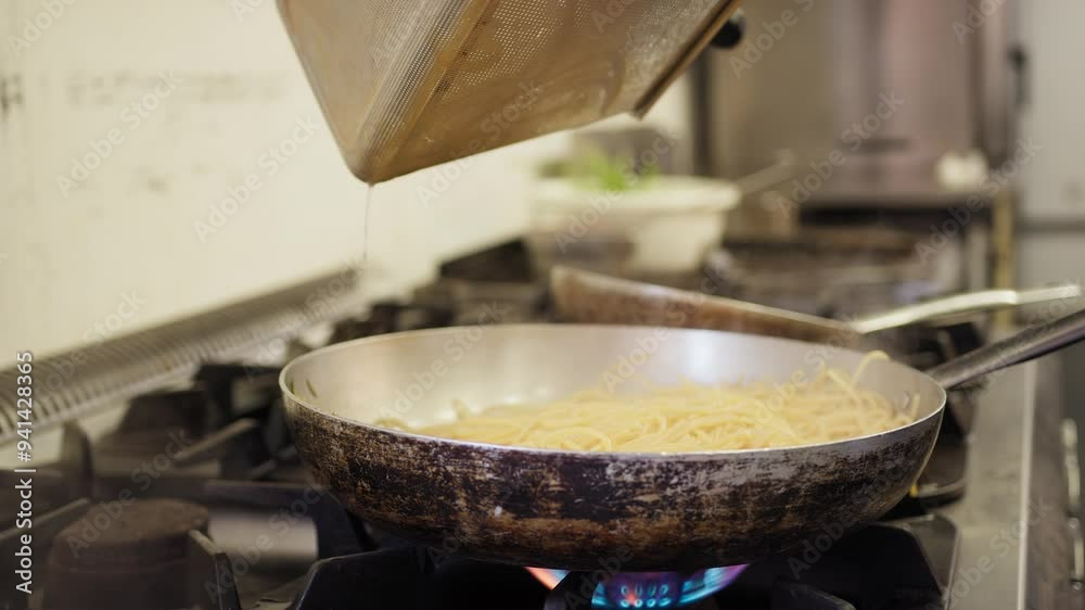 Chef Pours Spaghetti Pasta Into A Pan At A Restaurant Chef Pours Spaghetti Pasta Into A Pan At A Restaurant