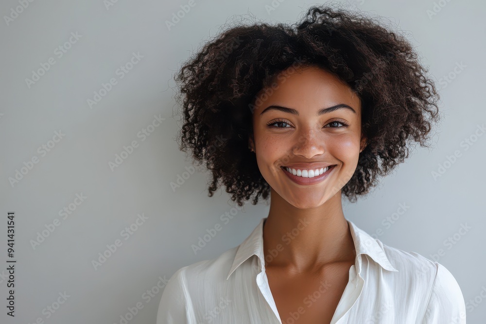 A series of portraits features a smiling young Black woman with natural curls, highlighted against simple white backdrops.
A series of portraits features a smiling young Black woman with natural curls, highlighted against simple white backdrops.