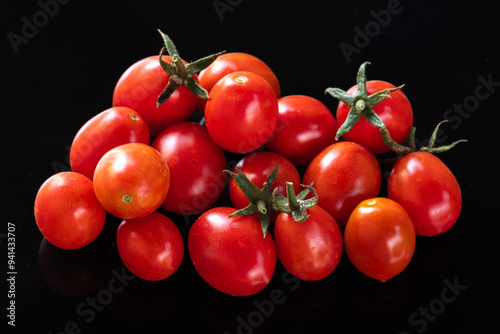 tomatoes on the vine, the delicious ripe red cherry tomatoes on the reflected plane during the day, exquisite datterini.A vibrant close-up, where the tomatoes are ripened in the sun, the morning light