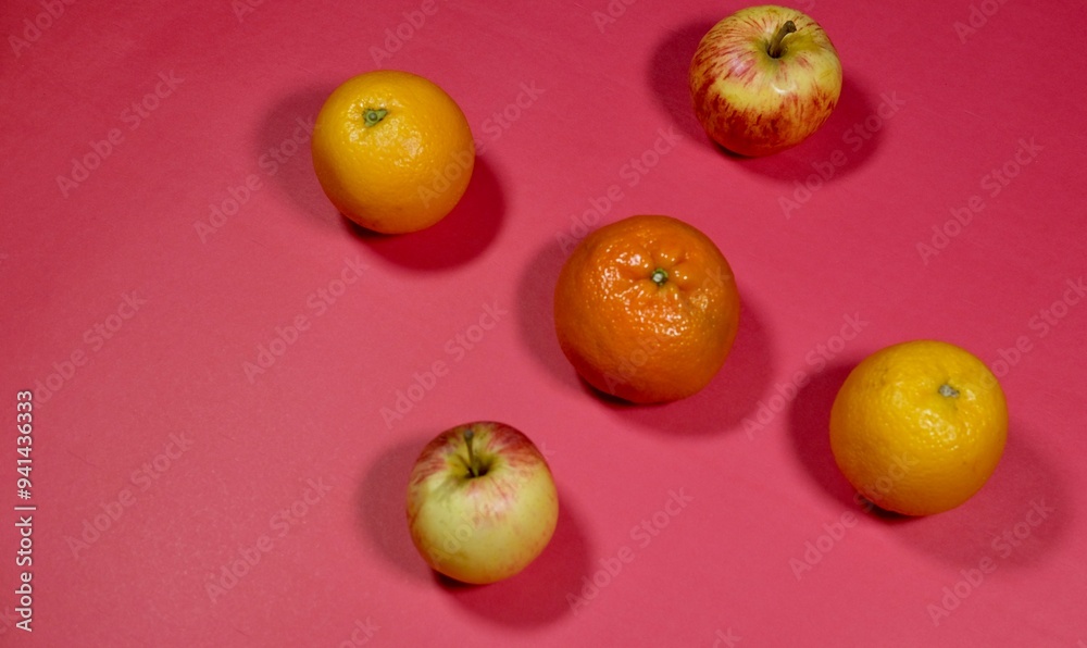 fresh apple, orange and malta on red background fresh apple, orange and malta on red background