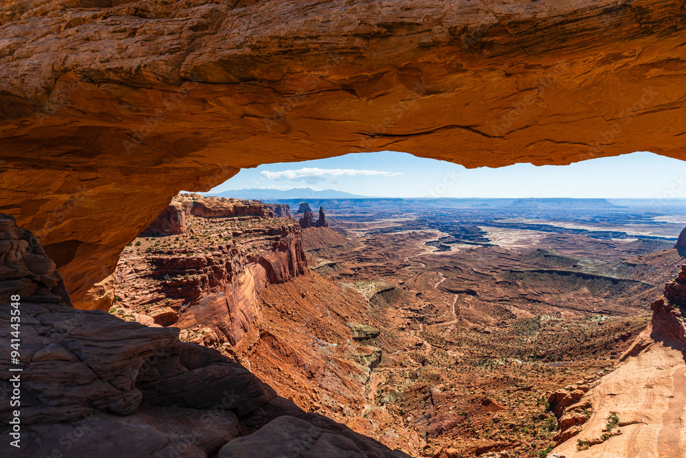 The most famous landmark of the Island in the Sky District of Canyonlands national park in Utah USA - The Mesa Arch in a blue day.