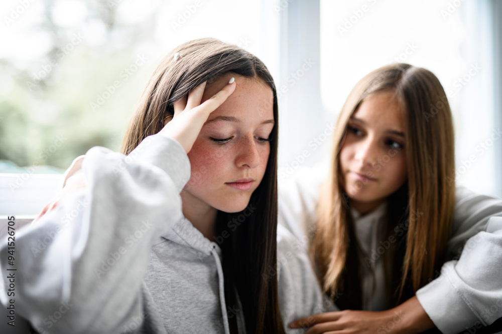 Depress and sad Teen girl sit on sofa wearing hoodies Depress and sad Teen girl sit on sofa wearing hoodies