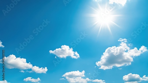 The sky is blue with a few clouds and the sun is shining brightly. Scene is bright and cheerful