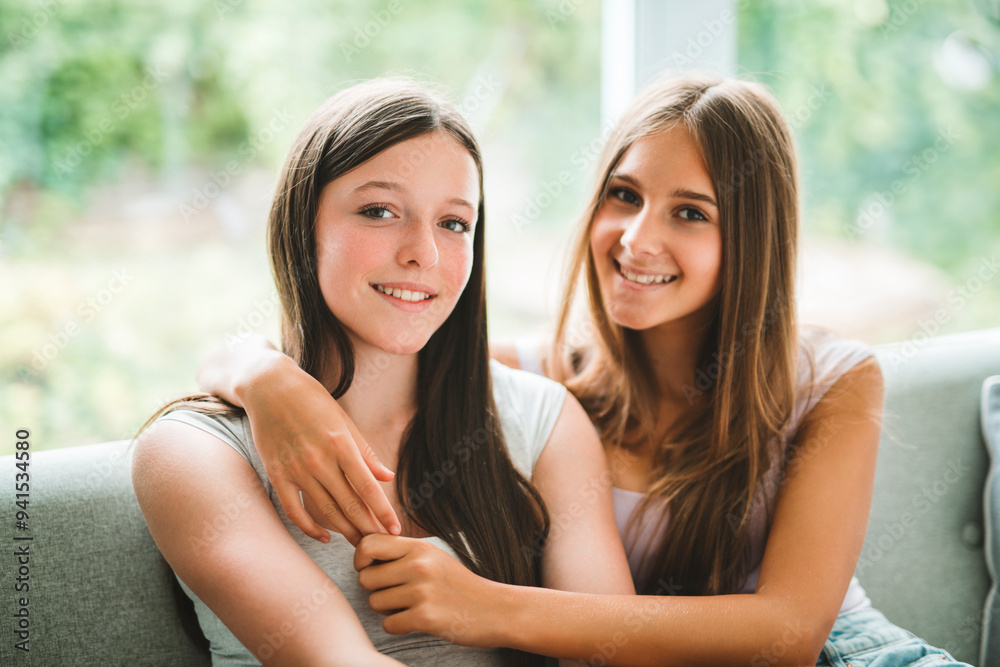 Fototapeta premium Two best girls having fun together on white studio