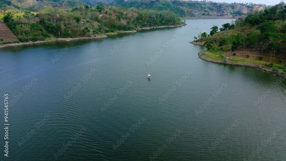 Aerial view of green lake on the forest land with fisherman ship Aerial view of green lake on the forest land with fisherman ship