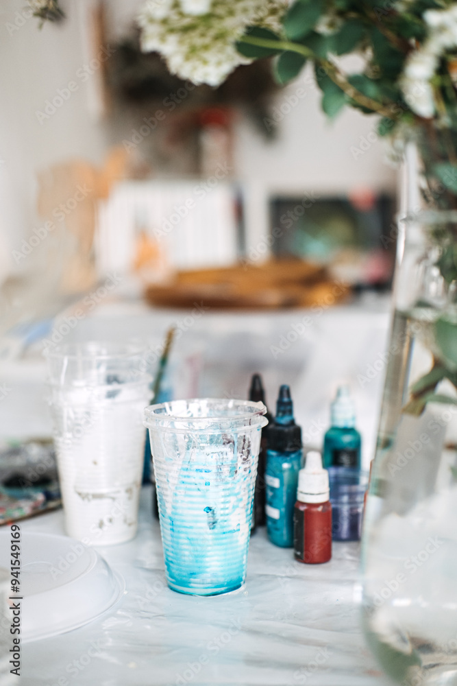 Creating colorful epoxy resin art during a DIY workshop with vibrant supplies and a floral backdrop Creating colorful epoxy resin art during a DIY workshop with vibrant supplies and a floral backdrop