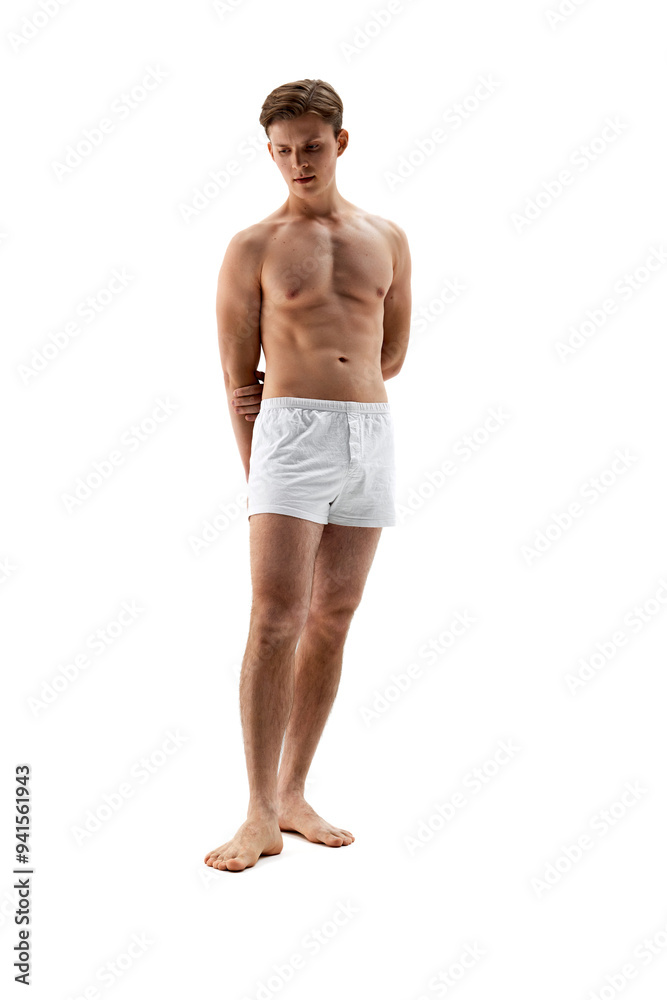 Young man with athletic body posing shirtless, in white underwear, shows his muscles against white studio background. Concept of male health, natural beauty people, fashion, self care. Ad Young man with athletic body posing shirtless, in white underwear, shows his muscles against white studio background. Concept of male health, natural beauty people, fashion, self care. Ad