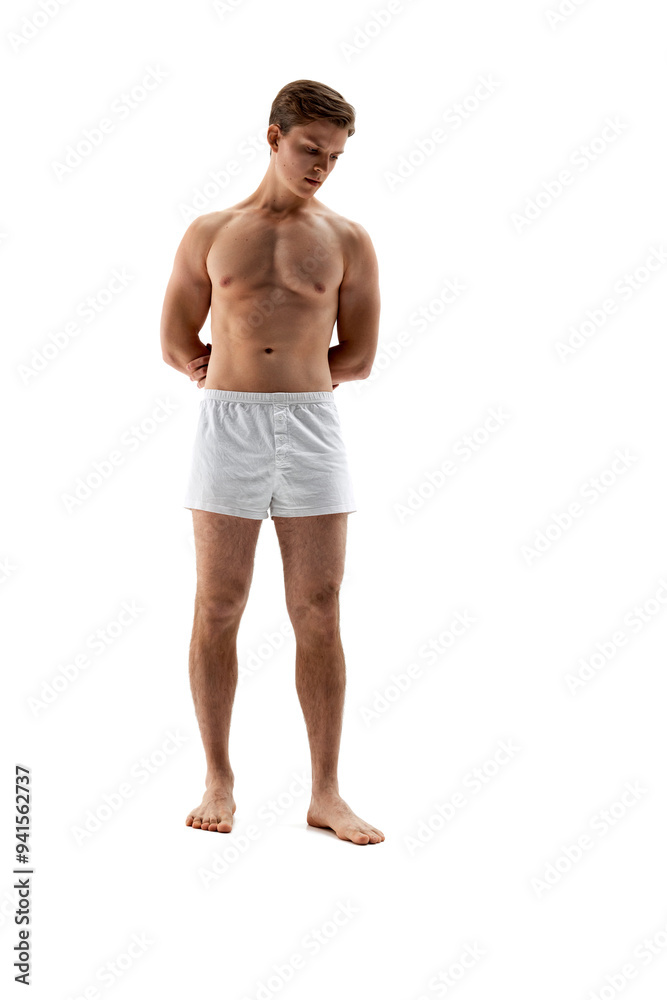 Full-length photo of young man with muscular, toned body, man posing in underwear against white studio background. Concept of male health, natural beauty people, fashion, self care. Full-length photo of young man with muscular, toned body, man posing in underwear against white studio background. Concept of male health, natural beauty people, fashion, self care.