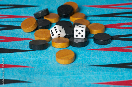 Checkers and dices on a backgammon board