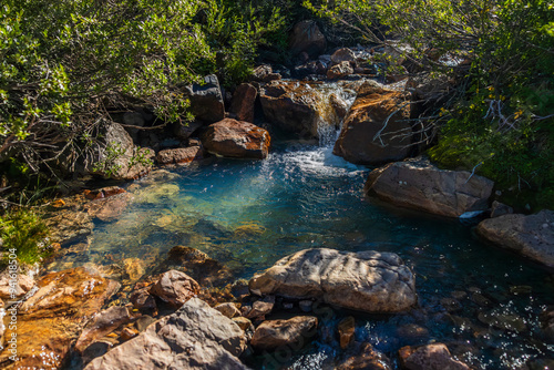 clear blue pool from mountain stream in the early morning
