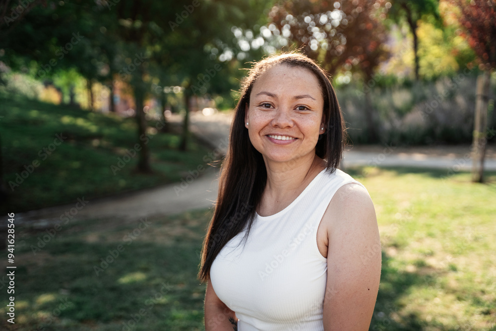 Portrait of smiling colombian woman enjoying a sunny day in a lush green park Portrait of smiling colombian woman enjoying a sunny day in a lush green park