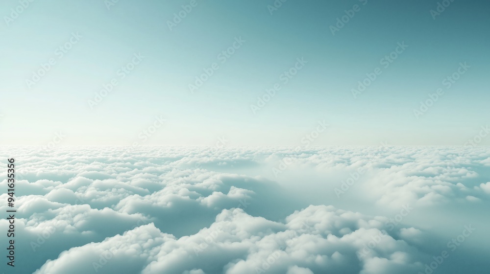 Naklejka premium A breathtaking view above the clouds with a serene blue sky, capturing the tranquility and expanse of nature.