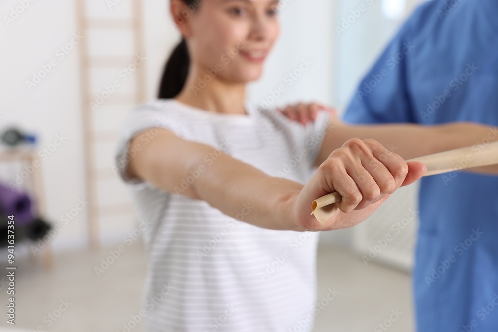 Fototapeta premium Patient exercising under physiotherapist supervision in rehabilitation center, selective focus