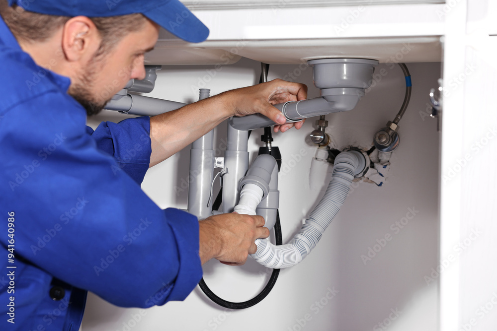 Fotografie Professional plumber fixing piping system at home