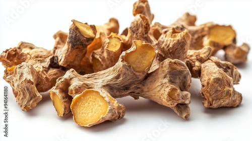 Pile of dried ginger roots isolated on a white background 
