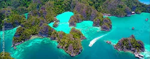 
Discover Raja Ampat in Papua, Indonesia, with amazing turquoise waters, stunning sandbanks, and vibrant sea life. Perfect for a holiday, enjoy a drone's aerial view of this tropical paradise