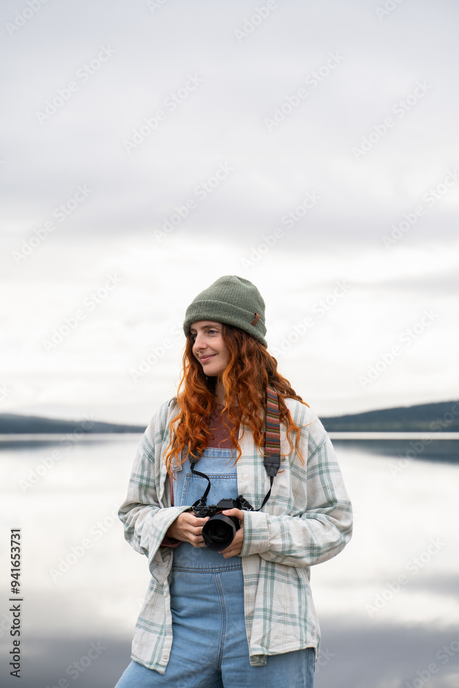 Young woman enjoying photography at a lakeside campsite Young woman enjoying photography at a lakeside campsite