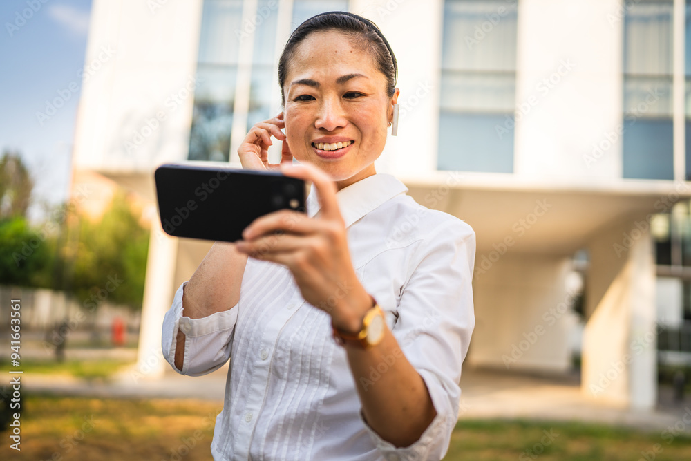 japanese woman stand in front buildings and have video call japanese woman stand in front buildings and have video call