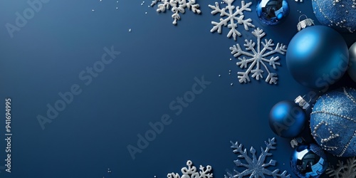 A stylish Christmas background featuring blue and silver baubles and snowflakes on a deep blue backdrop. Perfect for festive, holiday, or winter-themed projects, evoking elegance and seasonal charm.