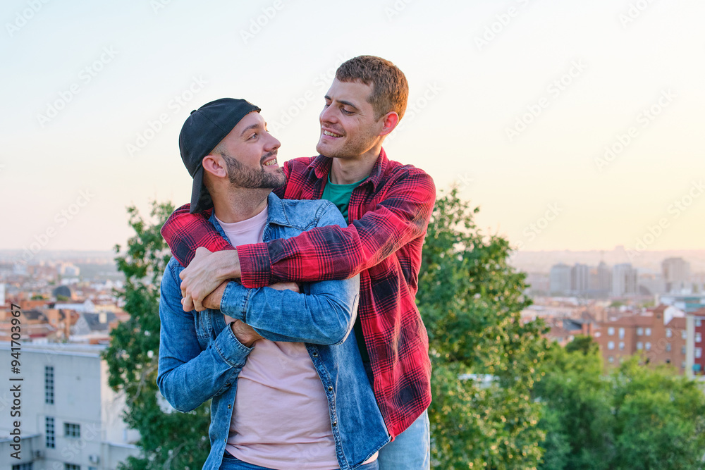 Gay couple embracing with joyful affection outdoors