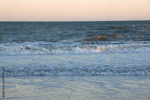  Sea landscape. Sea background at sunset with waves breaking on the beach. Concept of vacations, travel, calm, peace, relaxation.