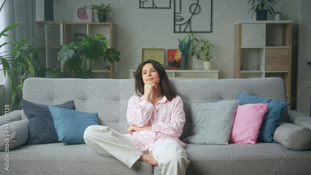Young woman relaxing at home sitting on couch and Young woman relaxing at home sitting on couch and