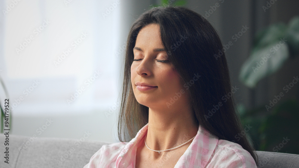 Young woman relaxing on couch with eyes closed Young woman relaxing on couch with eyes closed