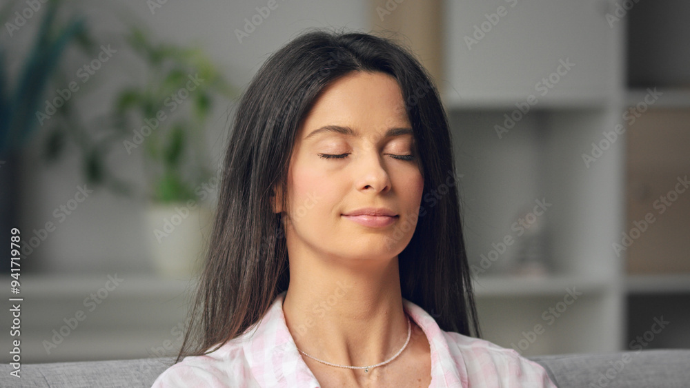 Young woman relaxing at home with eyes closed Young woman relaxing at home with eyes closed