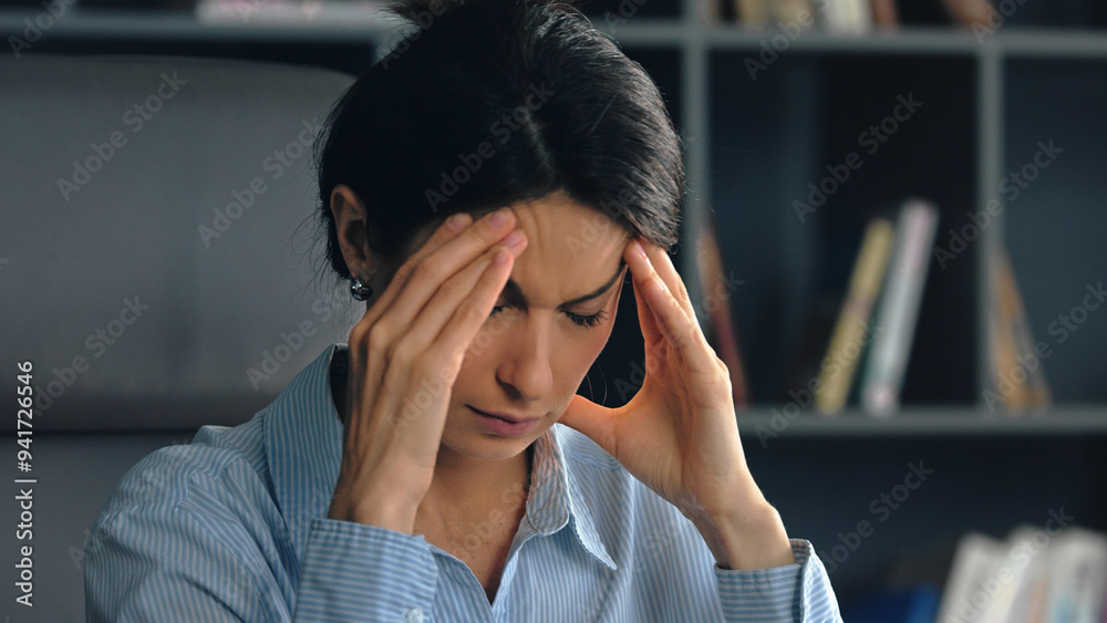 Businesswoman suffering from headache touching Businesswoman suffering from headache touching