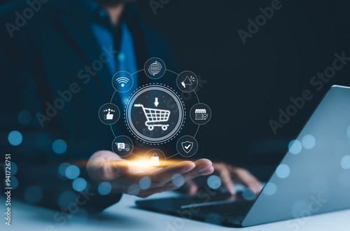 E-commerce technology concept. A person holding shopping cart icon with e-commerce symbols represents online shopping technology and digital marketing. customer service, delivery, reach, satisfaction,