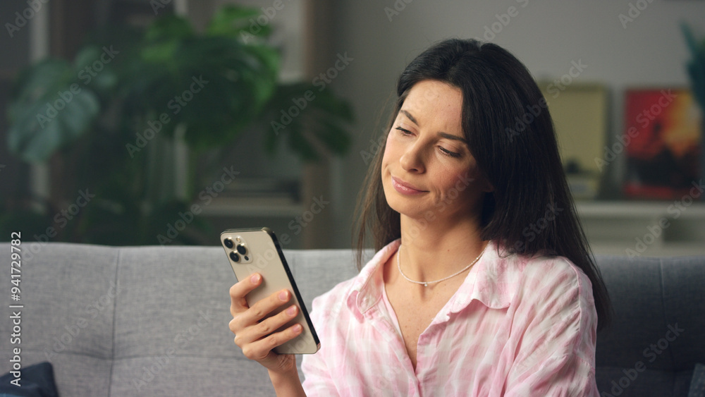 Beautiful woman relaxing on sofa using smartphone Beautiful woman relaxing on sofa using smartphone